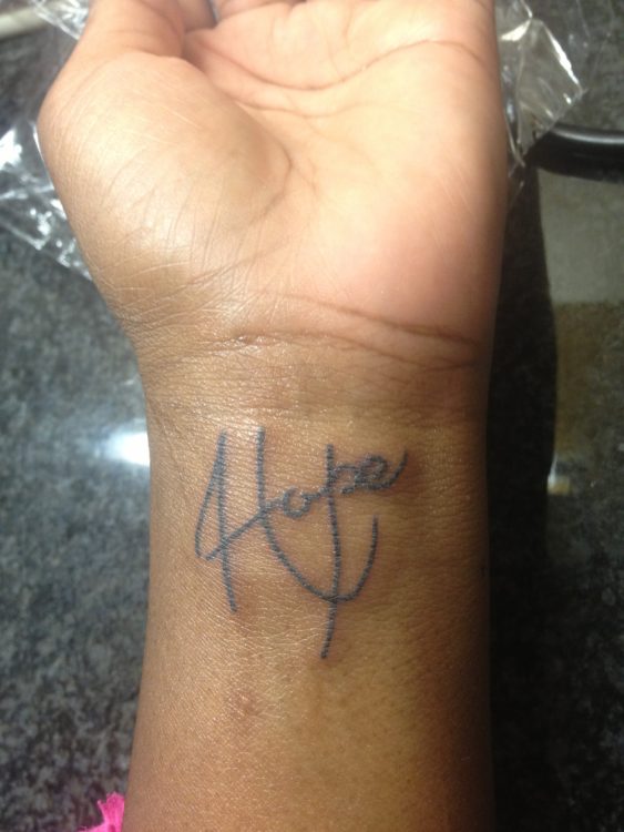 the word 'hope' tattooed on a woman's arm