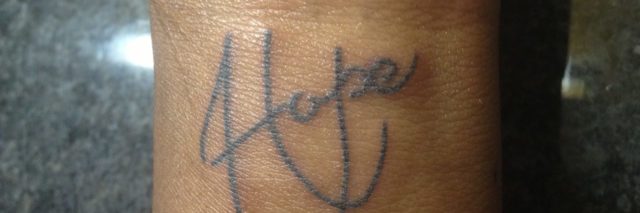 the word 'hope' tattooed on a woman's arm
