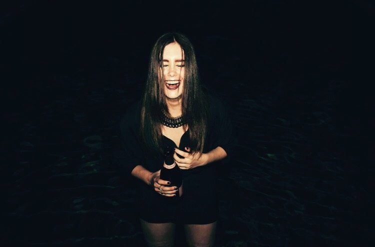 woman dressed in black and laughing