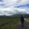woman walking down a road in scotland