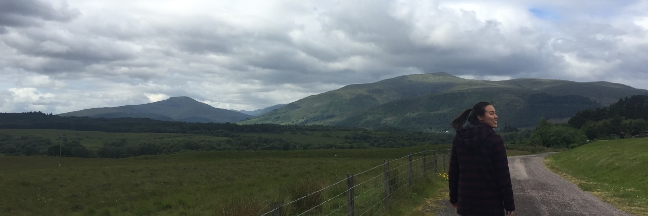 Wanting to Live Abroad When You Have Lupus and Take Immunosuppressants woman walking down a road in scotland