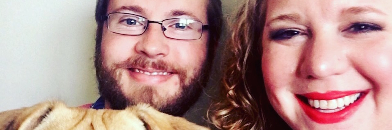 Migraine: Importance of Social Media for People With Chronic Illness woman smiling with her fiance and dog