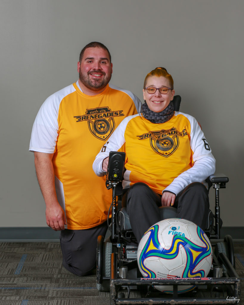 My husband and I in our Power Soccer Team jerseys. Me as a player, my husband as coach.