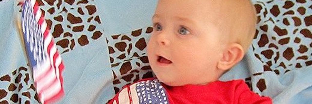 baby holding an american flag