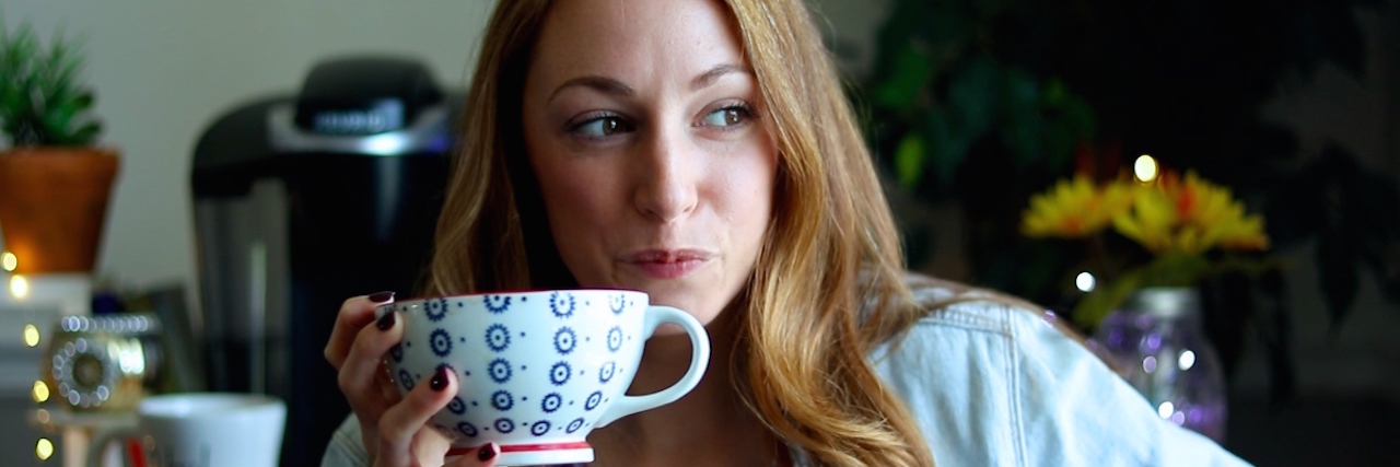 The Pep Talk I Give Myself When My Illness Makes Me Feel Angry The writer of the article, with a coffee mug in her hand.