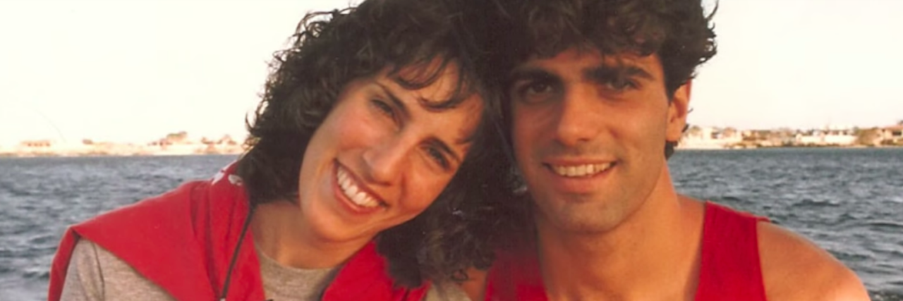 a film photo of a woman and husband next to each other on the beach