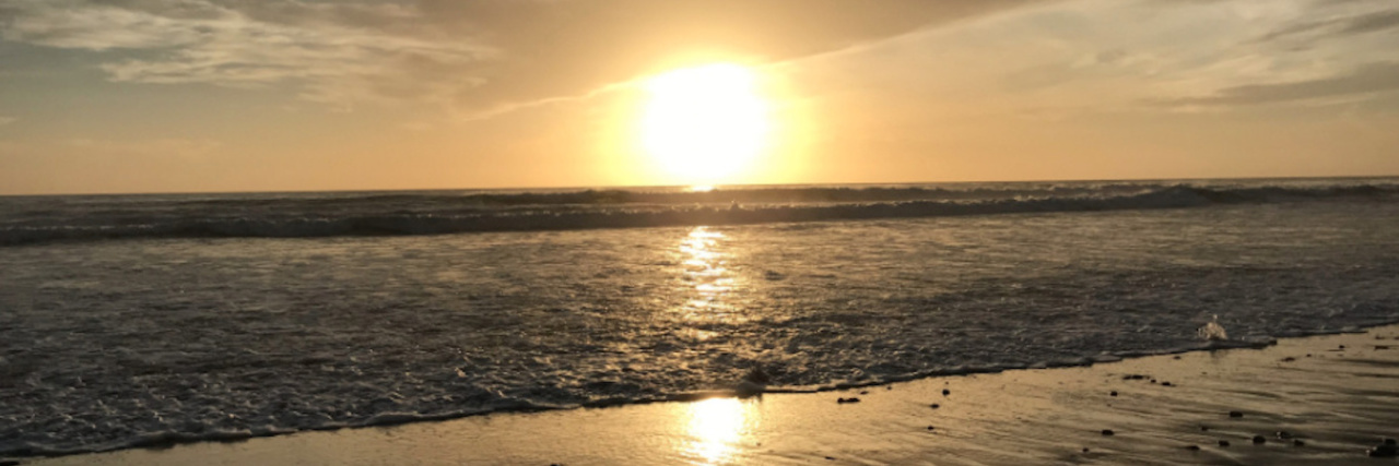 Living With a Rare Combination of Adult-Onset Mitochondrial Disease sunset over the ocean