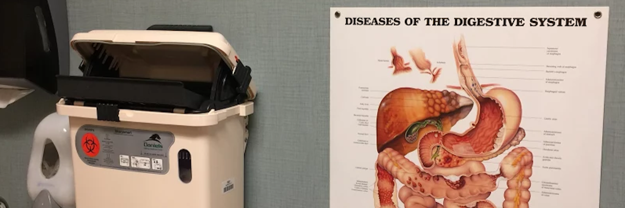 Being Scared of Going to the Doctor in Search of a Diagnosis doctor's office with a diagram of the digestive system on the wall