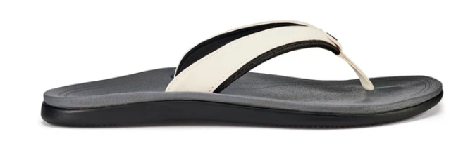 Pūnua women's beach sandals with black soles and an off-white strap