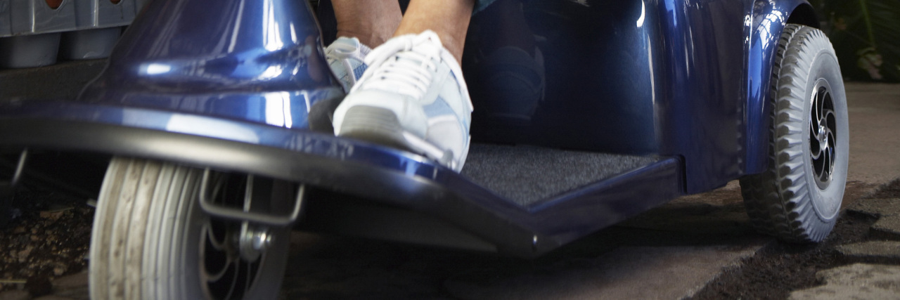 Using a Mobility Assistance Device Is Not Lazy Woman using a mobility scooter.