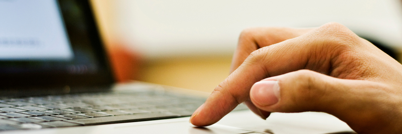 Dear Google, It's Time for You to Be an Eating Disorder Ally Student's finger on trackpad of computer.