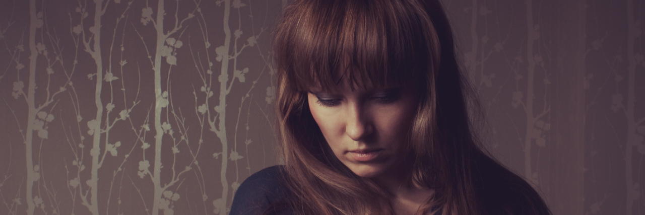 The Night My Blood Sugar Dropped and I Thought I Was Going to Die A woman standing in a room alone.