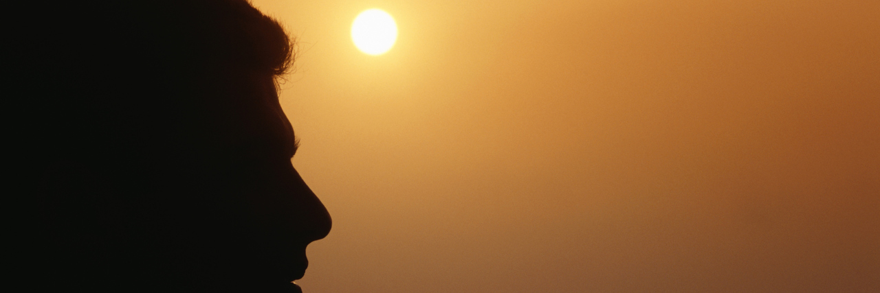 A Testicular Cancer Diagnosis Showed Me Who My Real Friends Were Man at sunset, profile, close-up