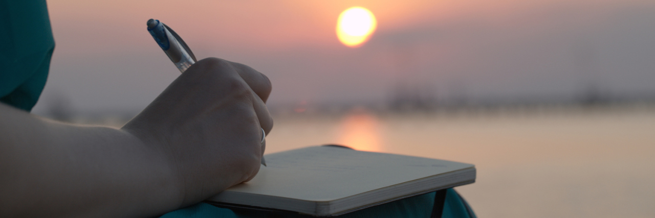 Grieving the Loss of My Father: What I Have Learned About Grief Woman writing in her diary at sunset
