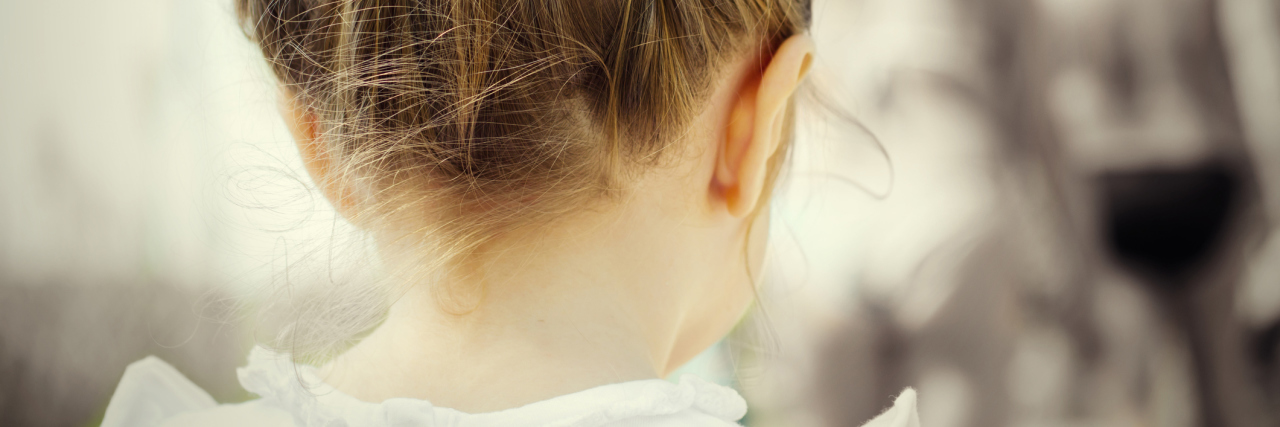 Why Your Pity Doesn't Help With My Dissociative Identity Disorder sad little girl in colour with black and white background, clips in her hair