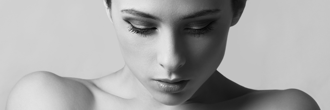 15 Things I Really Mean When I Say 'I'm Fine' A photo of a woman looking down.