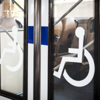 disability signs on the door of a bus