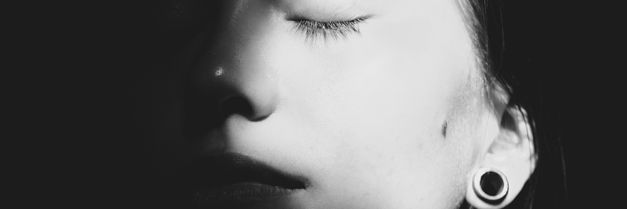 Why I Thought Suicide Was the Only Answer Close up Portrait of a Young Asian Woman with Closed Eyes.