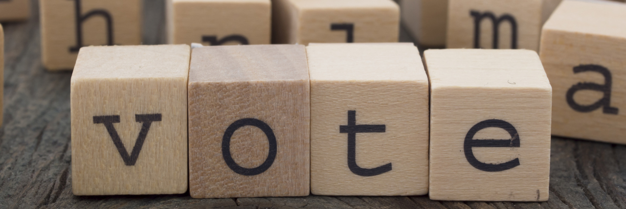 The word "vote" made of wooden cubes.