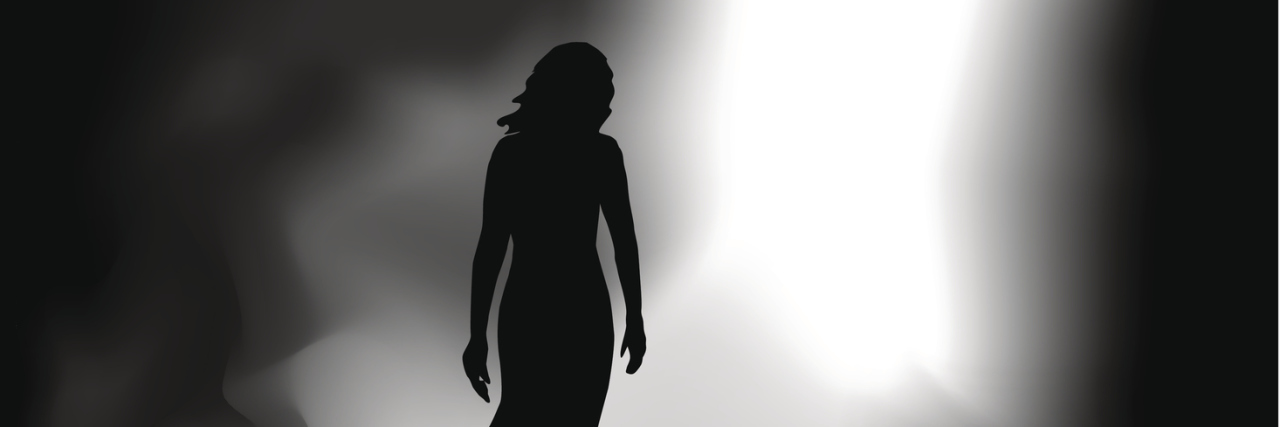 When I Couldn't Have Children Due to a Hysterectomy A woman walking from darkness to an entry way of light.