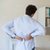 man holding his back in pain