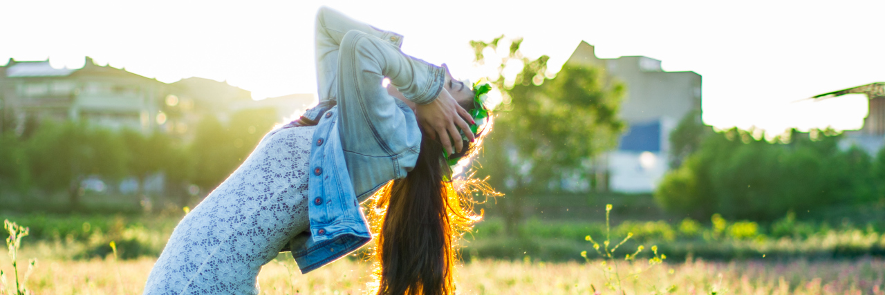 Not Apologizing for Falling Over Due to Undiagnosed Chronic Illness woman falling in a field