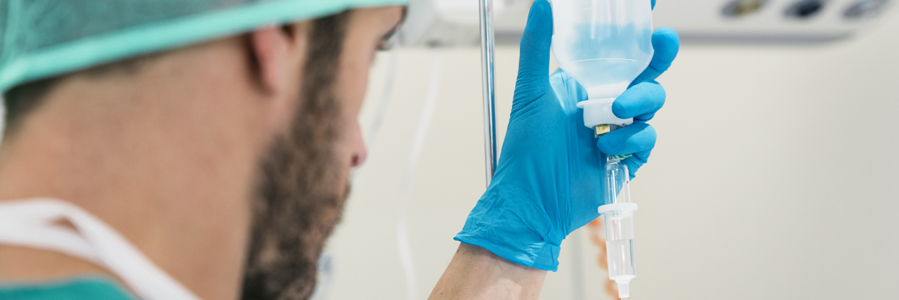 A Thank You to All the Nurses Who Have Made an Impact on My Life A male nurse hanging an IV bag.