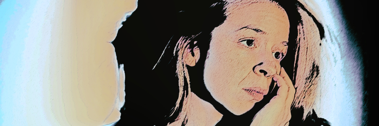 The Exhaustion of Autism Tired woman resting her head in her hand.