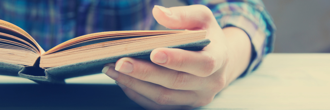 Closeup of woman reading book.