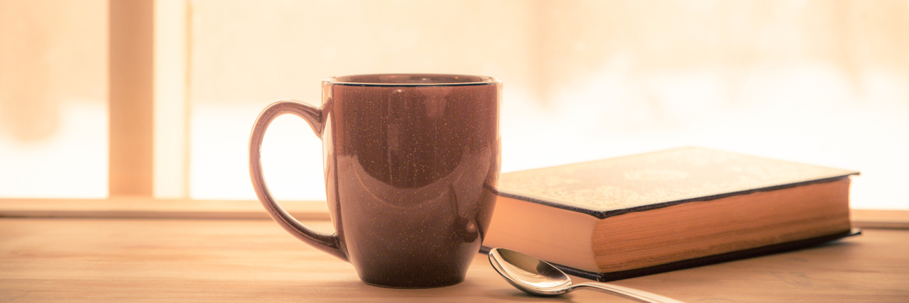 Encouraging Quotes for Tough Days With Chronic Pain and Illness coffee and book sitting on a shelf next to a window