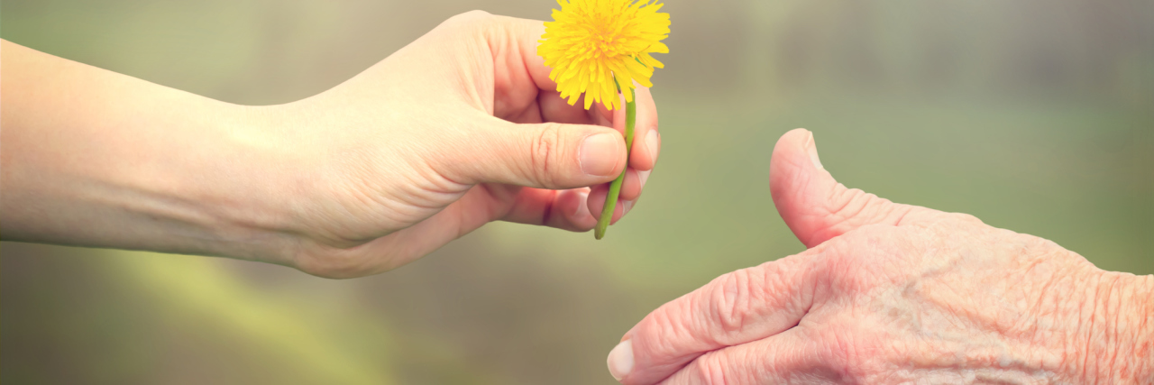 How My Grandmother’s Cervical Cancer Diagnosis Gave Me a Reality Check Senior woman sharing a flower with young girl