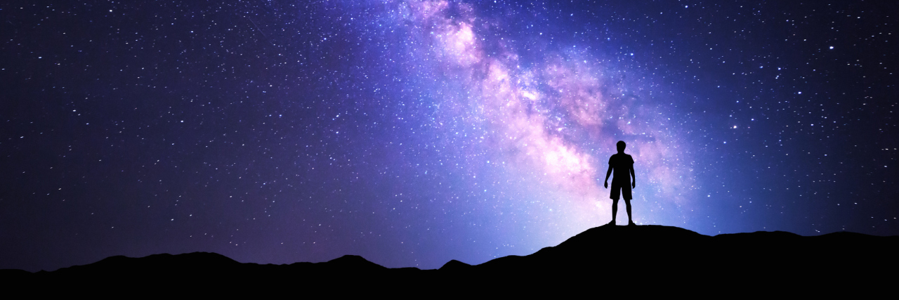 Finding Beauty in the Unknown With Undiagnosed Chronic Illness silhouette of a person standing against a starry night sky