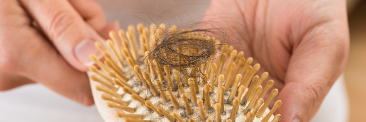 Struggling to Cope With Hair Loss From Chronic Illness lock of hair on a comb