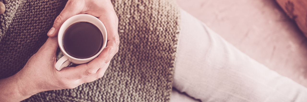 How to Set Boundaries to Protect Your Mental Health woman in bed holding cup of coffee