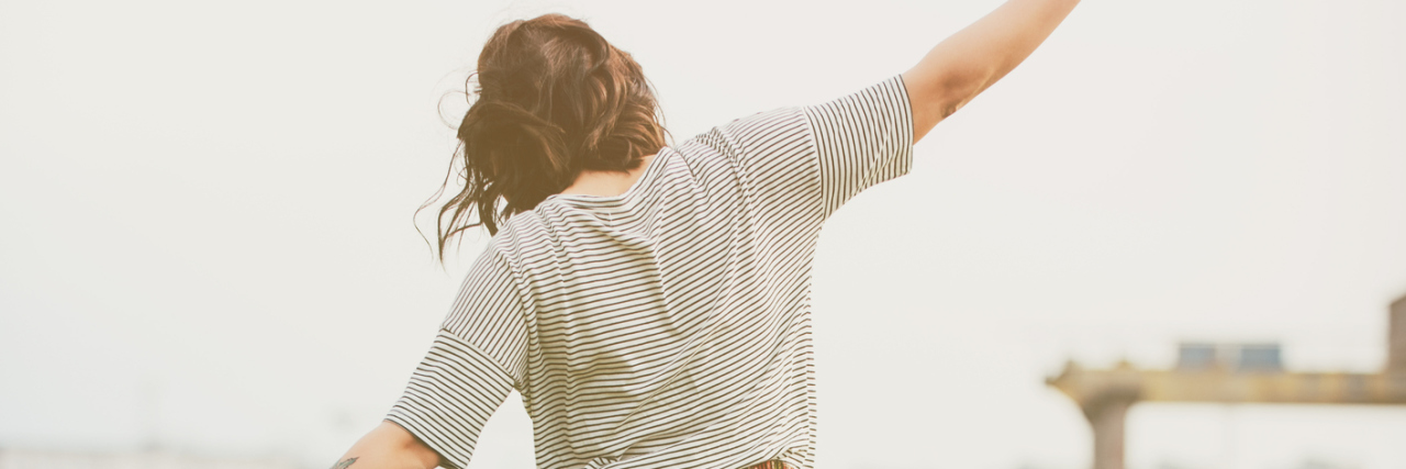 Managing Life With Irritable Bowel Syndrome (IBS) and Anxiety faded photo of woman walking on train tracks