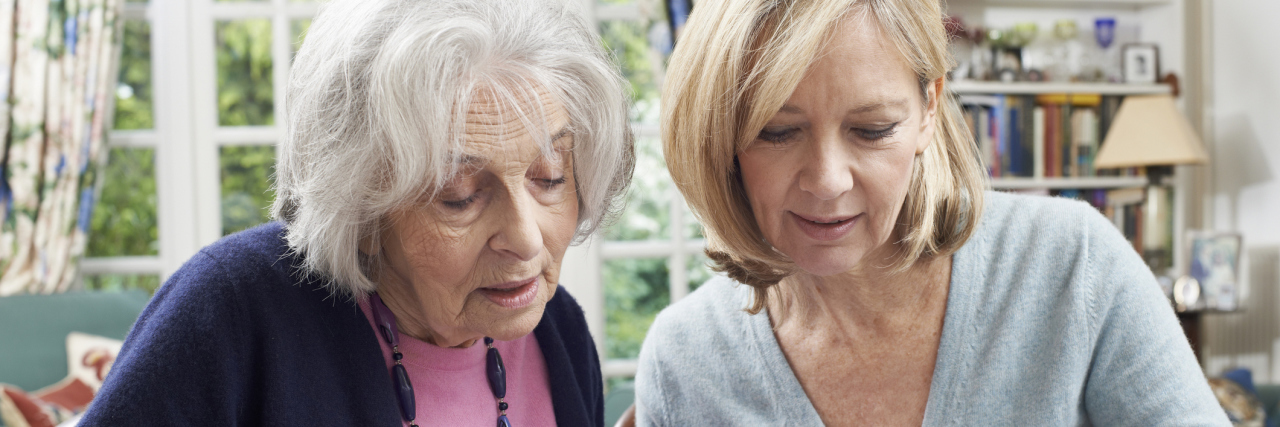 Ways Adult Children Can Help Their Parents With Depression Female Neighbor Helping Senior Woman To Complete Form