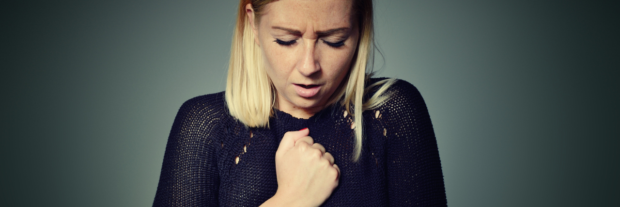 Why a Second Opinion Is Important When You Have Anxiety woman with chest pain against plain background