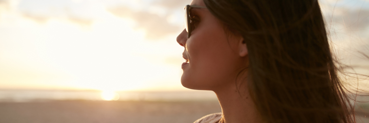 The Beauty of Hindsight After Being Diagnosed With Lupus woman wearing sunglasses and looking at ocean