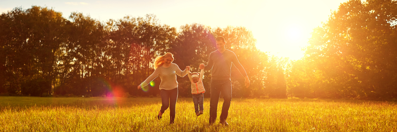 Conversation With My Husband Who Was Recently Diagnosed With Autism Happy family playing on the grass in the park in the evening.