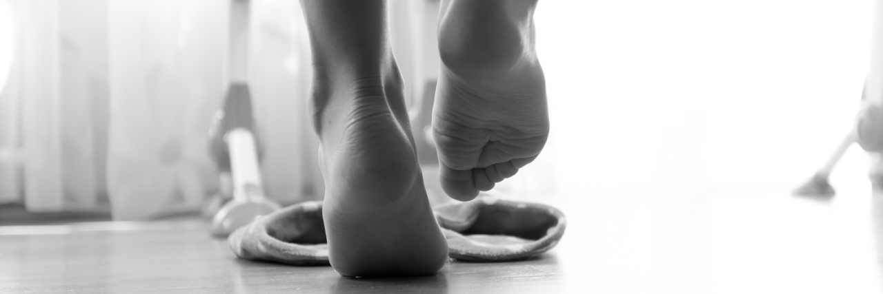 photo of from under the bed on woman wearing slippers