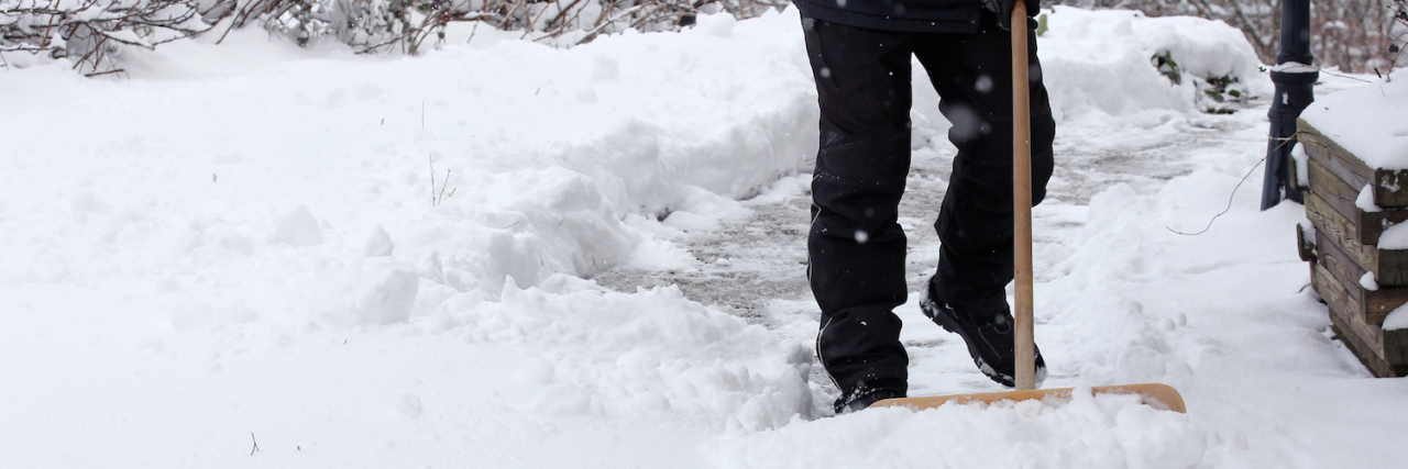 Lessons From My Father and Alzheimer’s person shovels snow from sidewalk
