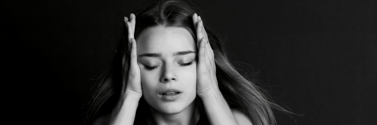 When Meniere's Disease Causes Vertigo and Hearing Loss A woman holding her head.