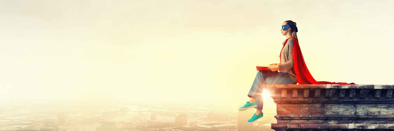 The 'Superhuman' Predicament When You're Diagnosed With Cancer female superhero sitting on edge of building