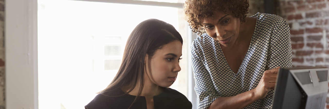 Don't Sell Yourself Short in the Work Place Because You're Ill Two women working in the office.