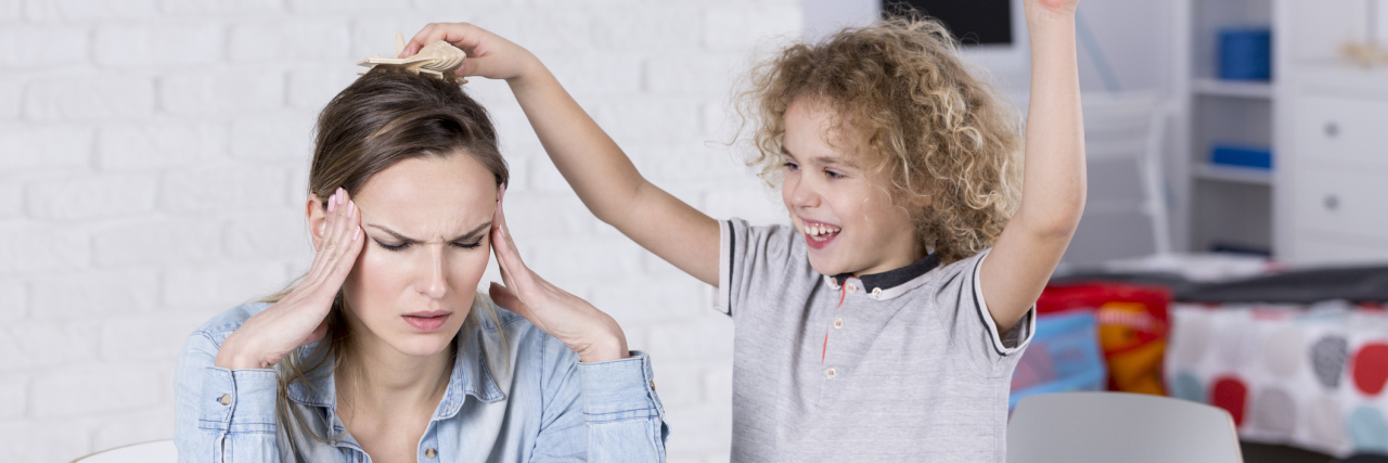 Why Mental Illness Makes Me Not Want to Have Kids Child annoying his tired mother with headache