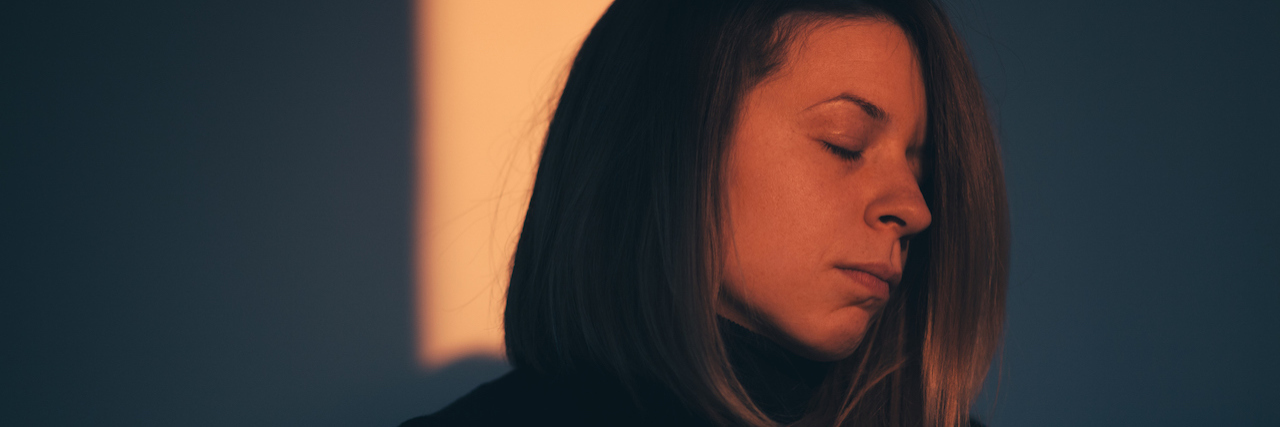 Suicide Awareness, and Access to Care for Those Who Are Suicidal A woman sitting in darkness