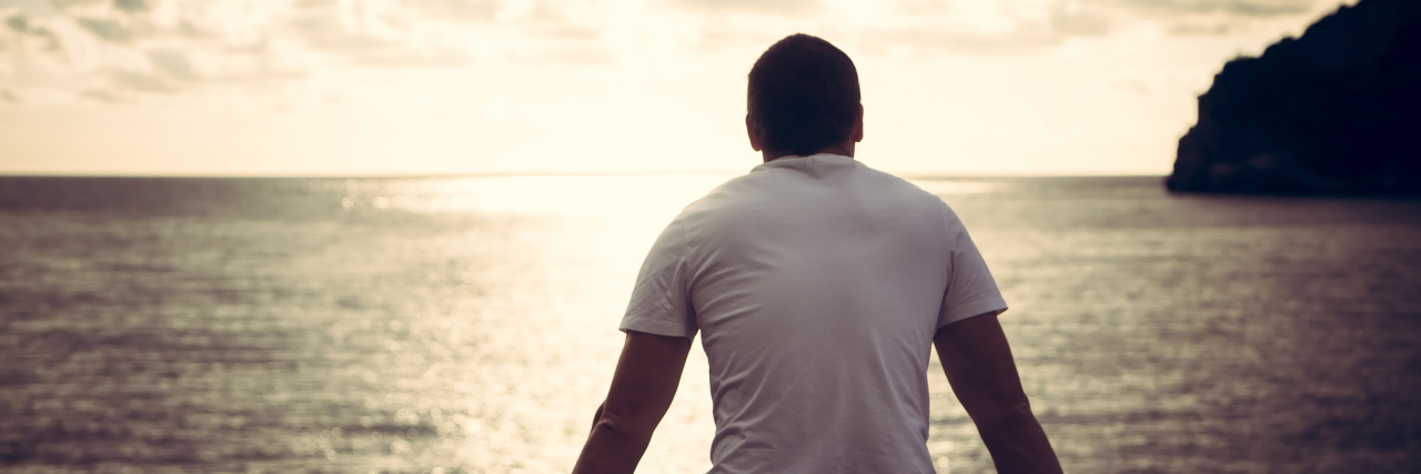 What Life Is Like With Eosinophilic Esophagitis (EoE) man sitting and looking at the ocean