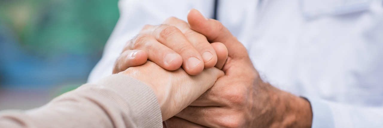The Grief of Losing a Doctor You Liked doctor holding a patient's hand