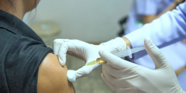 To the Pharmacist Who Judged Me for Getting the Flu Shot woman getting a flu shot