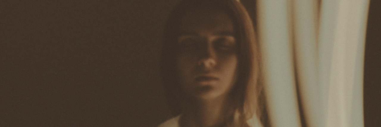 7 Things We Should All Know About Chronic Pain A photo of a woman with a light affect.